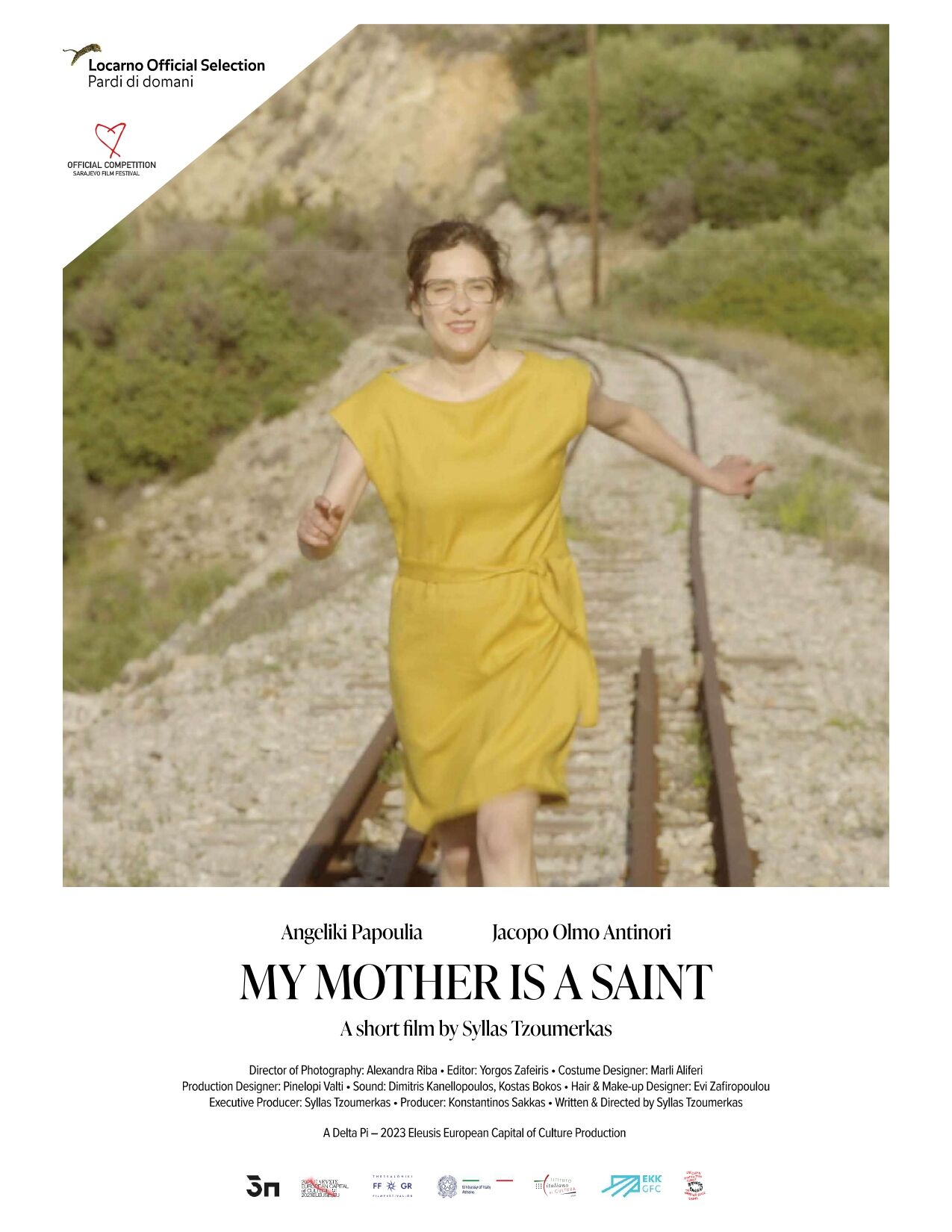 My Mother is a Saint film poster: actress Angeliki Papoulia in a yellow dress runs along railway tracks through green hills; festival laurels for Locarno (Pardi di domani) and Sarajevo Film Festival appear at the top, with title and credit block below.